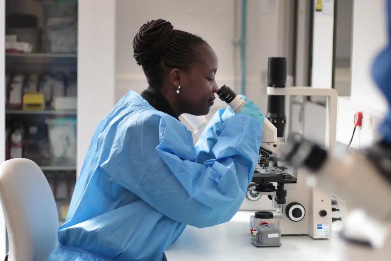 banner image of a woman working in a lab